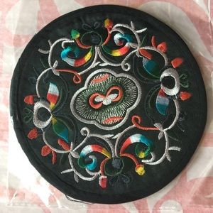 A pair of embroidered coasters
